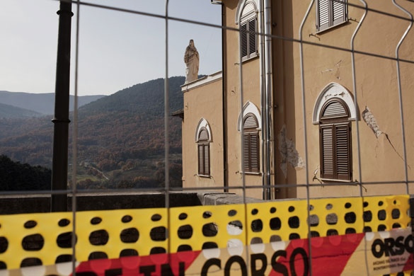 L'Aquila - 7 months later: A damaged building seen through a fence in the city