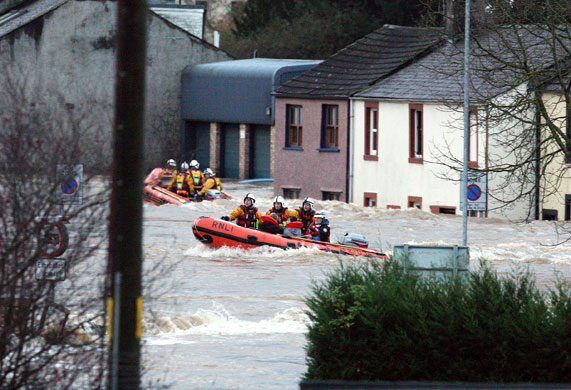 Weather flooding: Rescue services navigate the flood waters in the streets of Cockermouth