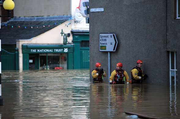 Weather floods: Rescue personnel do a door to door search in the High Street of Cockermouth
