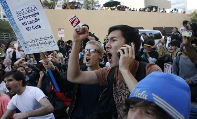 Student demonstrators block a van on UCLA's campus