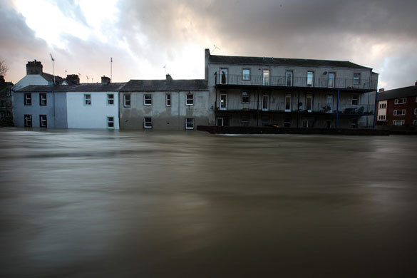 Weather floods: The River Cocker rages past homes in the centre of Cockermouth in Keswick