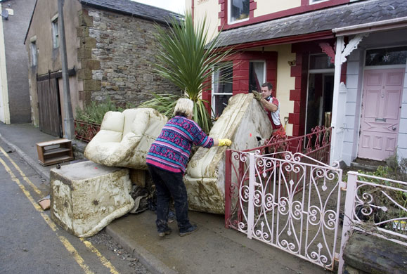 Cockermouth floods: Residents remove water damaged furniture from a house in Cockermouth