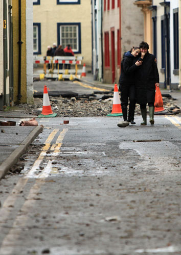 Cockermouth floods: Two women comfort each other as they return to their flood damaged home