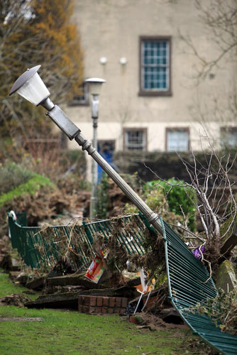 Cockermouth floods: A lamp is left at an angle as flood water recedes 