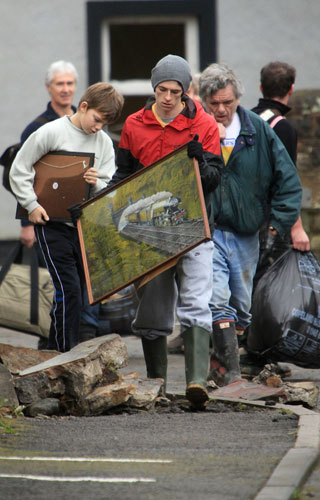 Cockermouth floods: Residents collect and pack up their belongings as they are evacuated
