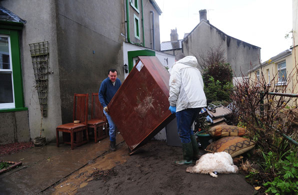 Cockermouth clear-up: Residents clear debris from their homes after flood water receded