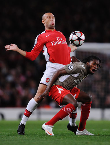 British Teams 2: Dieudonn Mbokani Bezua feels the full force of a Mikael Silvestre challenge