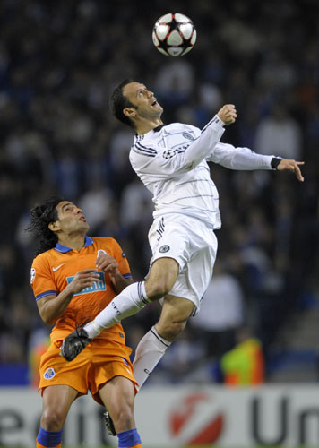 wed 3 champions: Ricardo Carvalho rises above Porto's Radamel Falcao to win a header