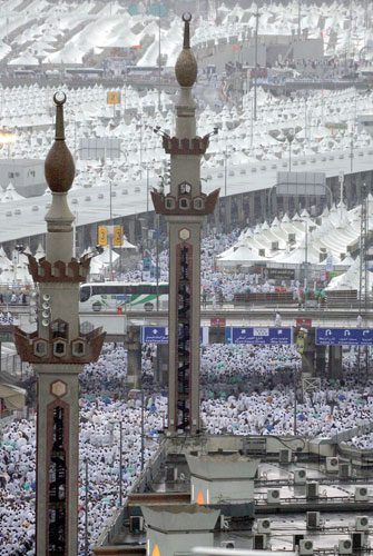 Mecca Hajj: Pilgrims attending the hajj walk on flooded streets during rain in Mina