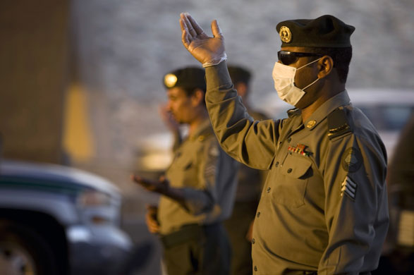 Mecca Hajj: Security officials keeps an eye on cars at a checkpoint 