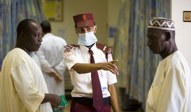 Mecca Hajj: A security guard directs Muslim pilgrims seeking medical care