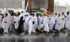 Pilgrims attending the hajj shelter from heavy rains in Mecca, Saudi Arabia.