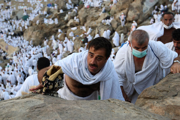 Mecca Hajj: Muslim pilgrims climb the Mountain of Mercy, near Mecca, Saudi Arabia