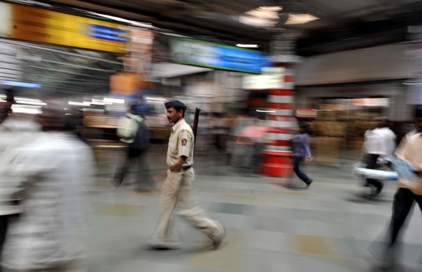 Mumbai anniversary: A policeman walks past at the Chattrapathi Shivaji Terminus