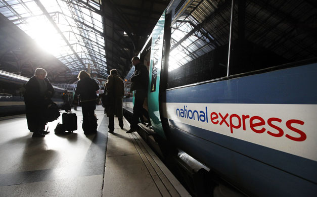 Week in business: Passengers disembark from a National Express train  in London