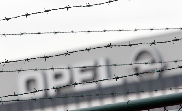 Week in business: An Opel logo through barbed wire at the Opel assembly plant in Antwerp