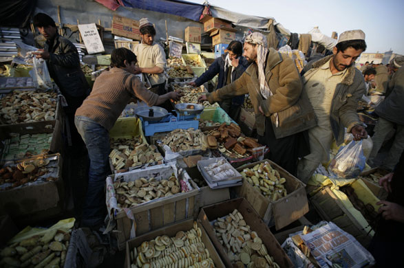 27 November 2009: Kabul, Afghanistan: Street vendors sell cookies and cakes