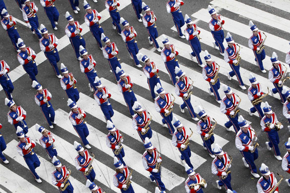27 November 2009: New York, US: A marching band passes through Times Square
