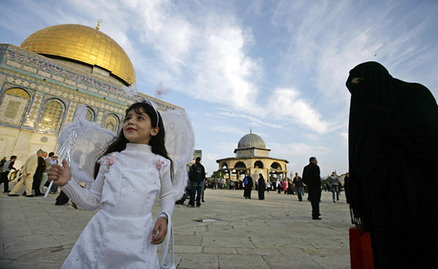 Eid al-Adha: A Palestinian girl dressed in costume 