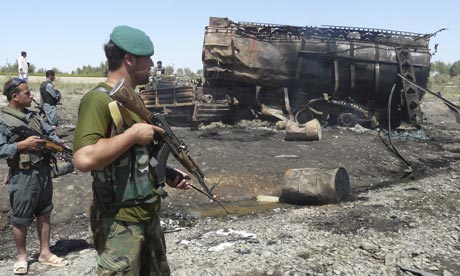 Afghan security forces guard a burned out tanker in Kunduz, after a Nato air strike killed civilians