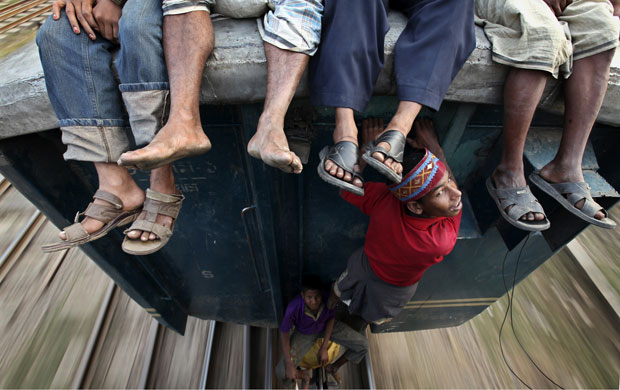 24 Hours in Pictures: People travel between train carriages to Jamalpur from Dhaka