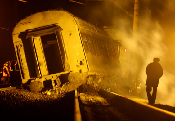 24 Hours in Pictures: Workers inspect a damaged railway carriage near from the village of Uglovka