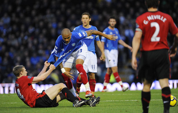 Pompey v United: Darren Fletcher gets two hands on the shirt of Kevin-Prince Boateng