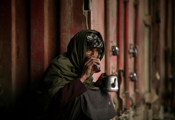 24 hours: Kabul, Afghanistan: A man drinks tea at a roadside shop 