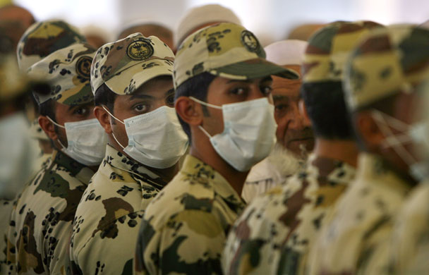 24 hours: Mina, Saudi Arabia:  Policemen, wearing protective masks against swine flu
