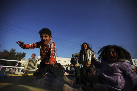 24 hours: Amman, Jordan: Children play in a park during  Eid al-Adha 