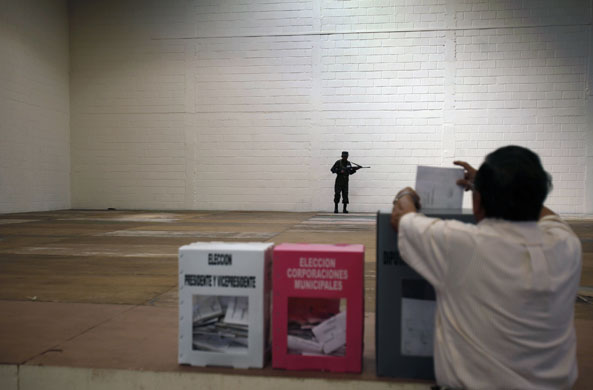 Honduras elections: A soldier stands guard in a polling station during Honduras elections
