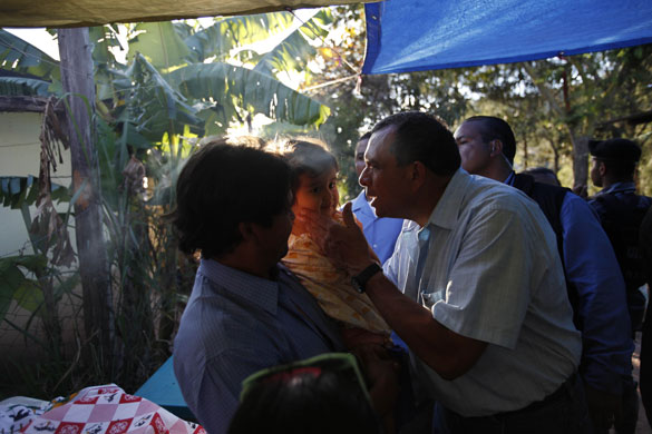 Honduras elections: Porfirio Lobo kisses a baby on polling day in Honduras elections