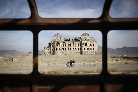 30 November 2009: Kabul, Afghanistan: People pass by the Darulaman Palace