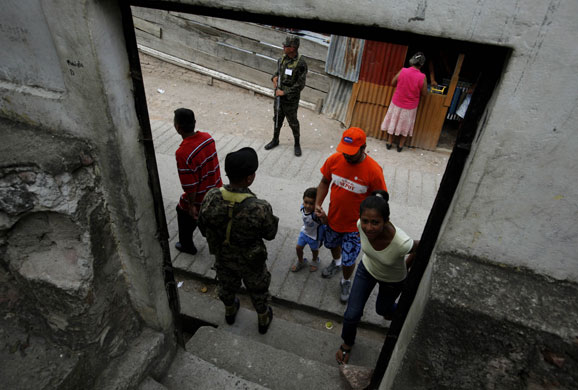 30 November 2009: Tegucigalpa, Honduras: Soldiers stands guard at a polling centre