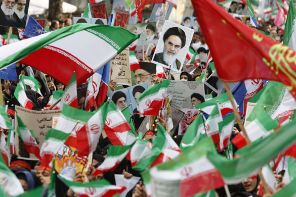 Iran protests: Iranian school girls wave flags at an annual demonstration