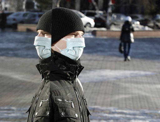 24 hours: Krasnoyarsk, Russia: A man wearing a surgical mask against H1N1 infection