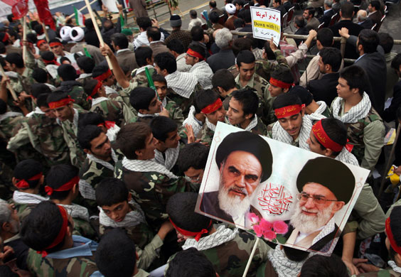 Iran protests: Iranian members of the Basij militia hold portraits
