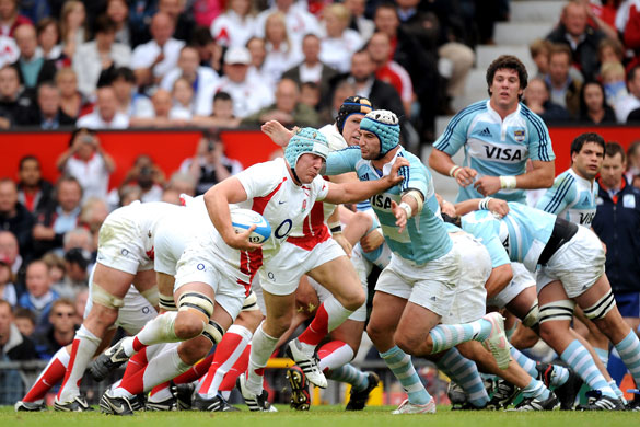 England Rugby Team: England's Jordan Crane evades an Argentinan tackle
