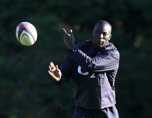 England Rugby Team: Ayoola Erinle passes the ball during the England training session 