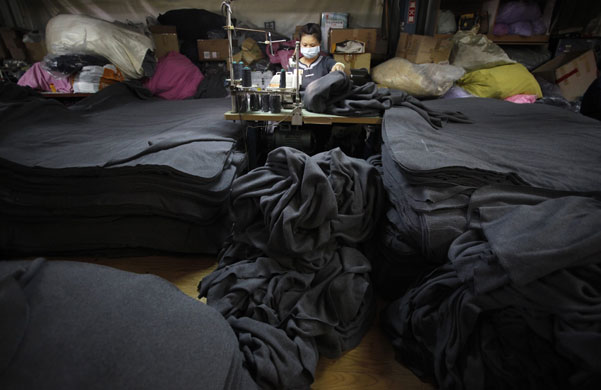 24 hours: Taipei, Taiwan: A volunteer worker sews blankets made from plastic bottles 
