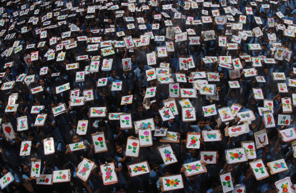 24 hours: Chennai, India: School children hold up their paintings at a school
