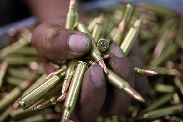 24 hours: Miami, US: A man holds a handful of .223-calibre cartridges