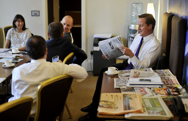Andrew Parsons Propaganda: David Cameron smiles at a cartoon of himself  in the Sunday papers