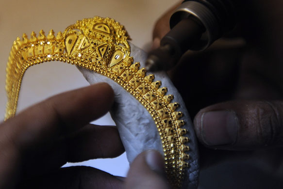 Week in Business: A jeweller works on a necklace in his workshop in Mumbai
