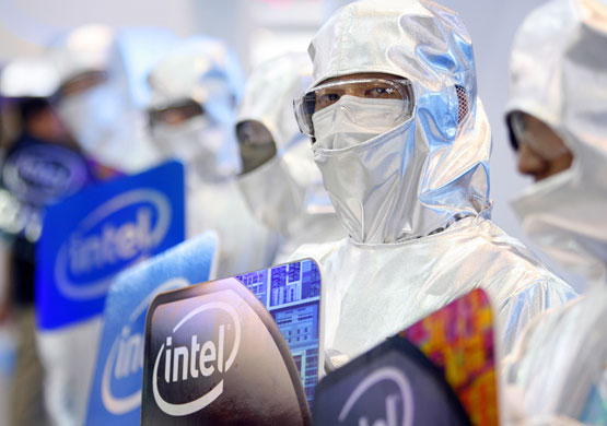 Week in Business: Men pose at the Intel booth during the 2009 Computex exhibition in Taipei