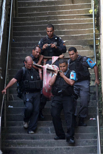 Slums in Rio De Janeiro: State Police Police (PMERJ) in Rio De Janeiro carry a body down a stairway