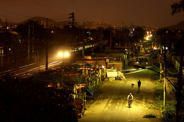 Slums in Rio De Janeiro: Shacks beside railroad tracks where the church distributes bread
