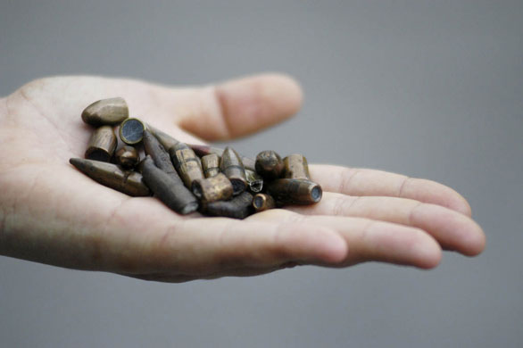 Slums in Rio De Janeiro: A worker displays bullets which hit a Hospital in Rio de Janeiro