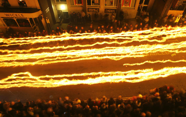Bonfire Night: Light trails of people carrying burning torches at Bonfire Night in Lewes