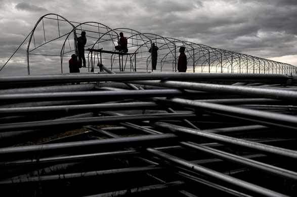 24 hours: Urosevac, Kosovo: Villagers work in a construction of a green house 